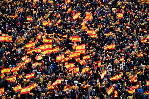 Rightwing protesters wave Spanish flags during a demonstration against the Spanish prime minister Pedro Sánchez. The conservative Popular party (PP), centre-right Ciudadanos and far-right Vox have all called on their supporters to take to the streets of Madrid against Sánchez after accusing him of making concessions to Catalan separatists
