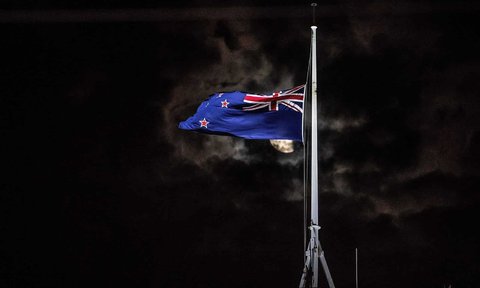 The national flag of New Zealand is flown at half-mast on a parliament building after the shooting incident in Christchurch.