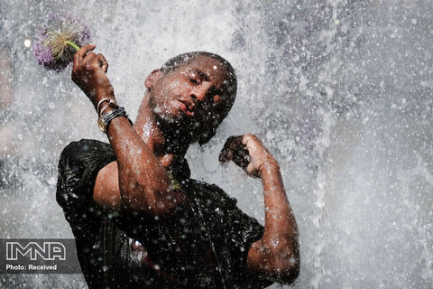 آب تنی یک مرد در مقابل فواره پارک واشنگتن اسکوئر در پی رفع محدودیت های کرونایی در نیویورک 