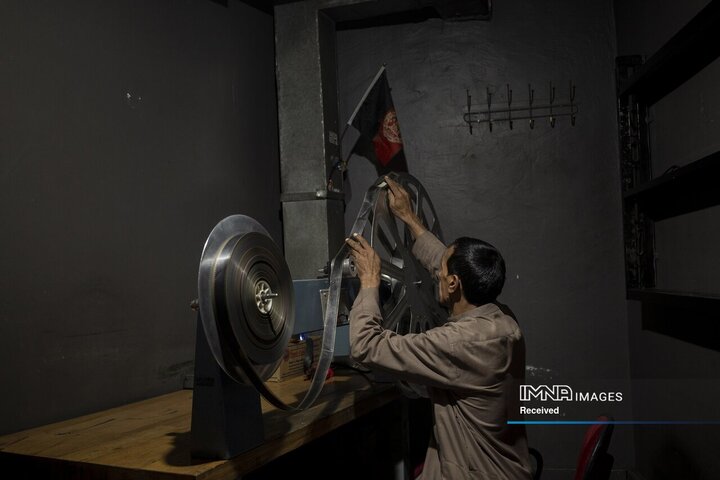 رحمت الله عزتی در اتاق پروجکشن سینما آریانا در کابل، افغانستان، یک رول فیلم را از نظر آسیب بررسی می کند. با وجود اینکه طالبان چند ماه قبل سینمای دولتی را بستند، هنوز هم کارمندان هر روز سر کار می آیند، به این امید که در نهایت دستمزد دریافت کنند.